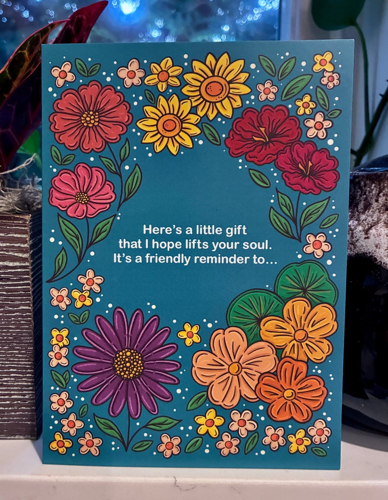 Floral greeting card standing on shelf with colorful illustrated flowers